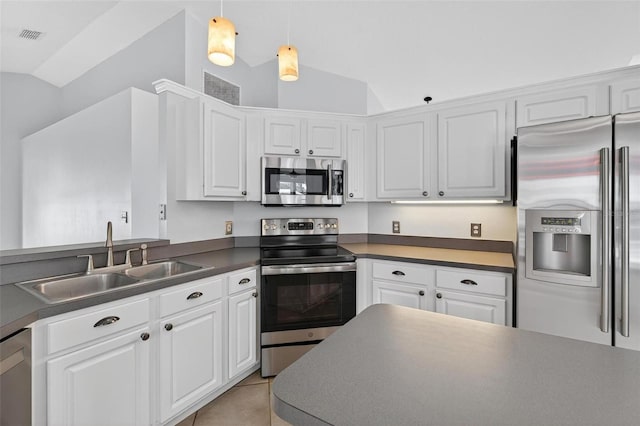 2705 Bayview Dr, Eustis, FL 32726 - kitchen featuring stainless steel appliances, a sink, lofted ceiling, and white cabinetry