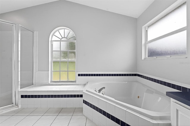 2705 Bayview Dr, Eustis, FL 32726 - full bath featuring a whirlpool tub, a shower stall, tile patterned floors, vaulted ceiling, and vanity