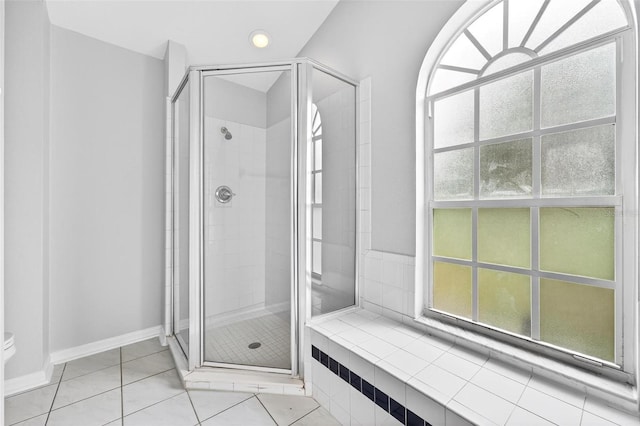 2705 Bayview Dr, Eustis, FL 32726 - bathroom with a stall shower, baseboards, and tile patterned flooring