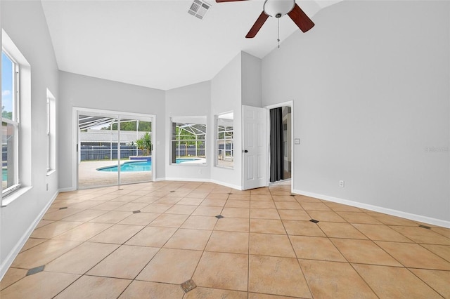 2705 Bayview Dr, Eustis, FL 32726 - unfurnished room featuring ceiling fan, high vaulted ceiling, light tile patterned floors, and baseboards
