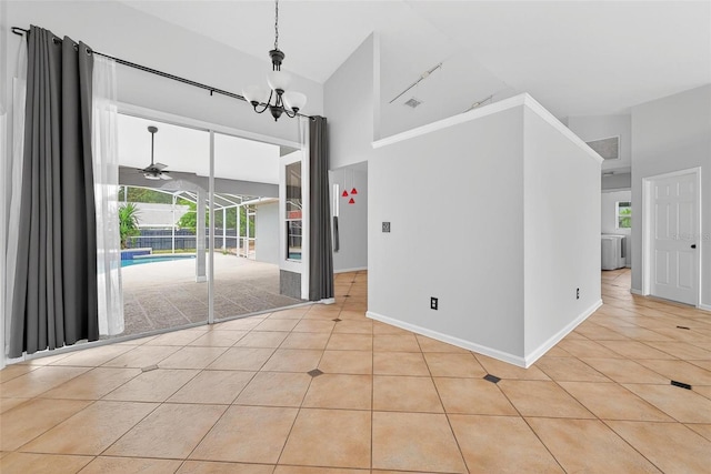 2705 Bayview Dr, Eustis, FL 32726 - empty room featuring high vaulted ceiling, light tile patterned floors, a chandelier, ceiling fan, and baseboards