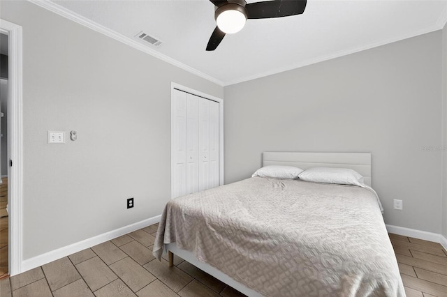 2705 Bayview Dr, Eustis, FL 32726 - bedroom featuring crown molding, wood tiled floors, baseboards, a closet, and ceiling fan