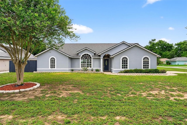 2705 Bayview Dr, Eustis, FL 32726 - ranch-style home featuring stucco siding, a front lawn, and a shingled roof