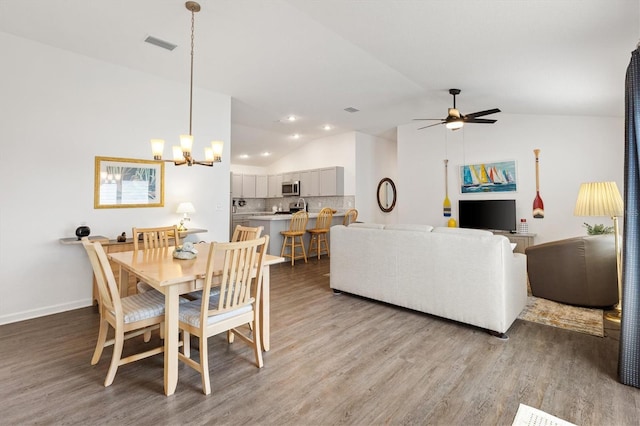 1225 Eunice St, The Villages, FL 34762 - dining space with vaulted ceiling, light wood-type flooring, ceiling fan, a chandelier, and baseboards