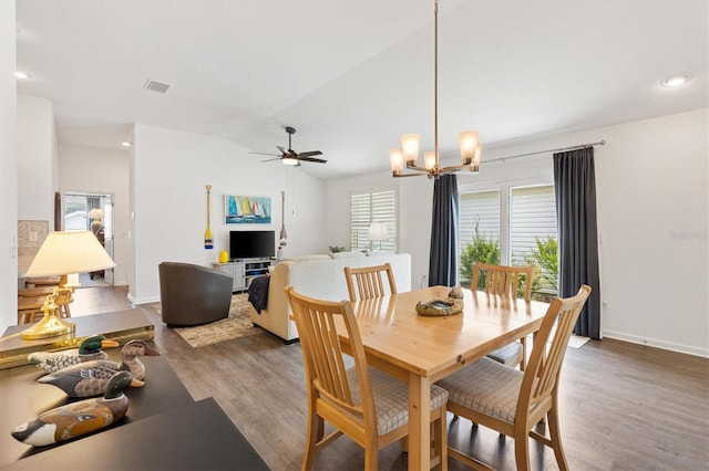 1225 Eunice St, The Villages, FL 34762 - dining area with wood finished floors, lofted ceiling, ceiling fan, baseboards, and a chandelier