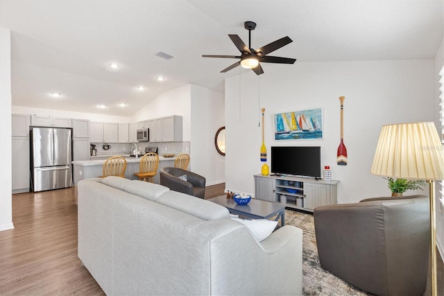1225 Eunice St, The Villages, FL 34762 - living area featuring lofted ceiling, a ceiling fan, light wood-style flooring, and recessed lighting