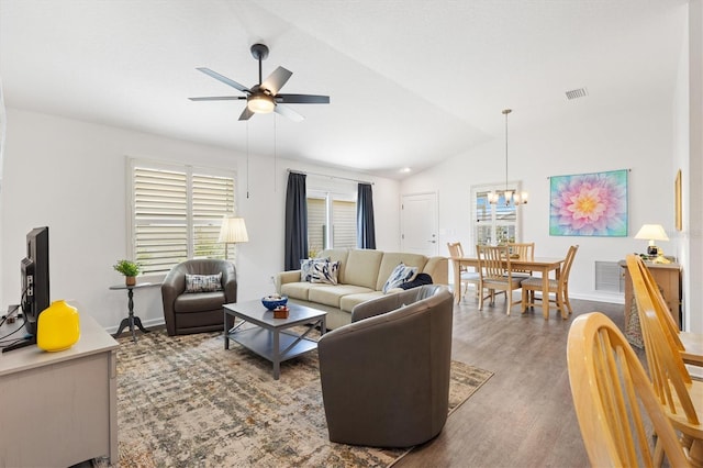 1225 Eunice St, The Villages, FL 34762 - living room with a ceiling fan, lofted ceiling, wood finished floors, a chandelier, and baseboards