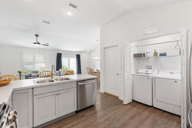1225 Eunice St, The Villages, FL 34762 - kitchen with stainless steel appliances, a sink, washing machine and dryer, dark wood-style floors, and ceiling fan