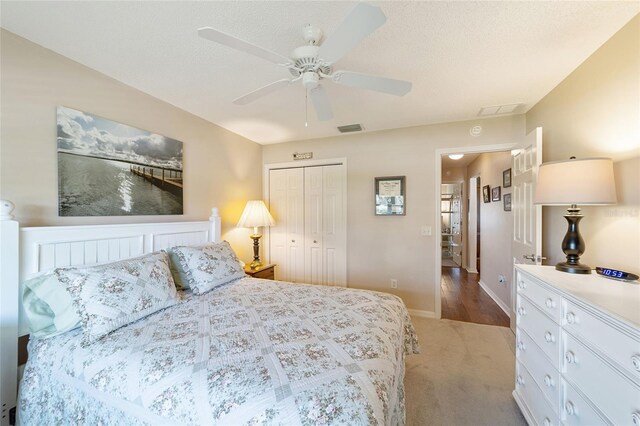 8537 SE 177th Bartram Loop, The Villages, FL 32162 - bedroom with a closet, light colored carpet, ceiling fan, and baseboards