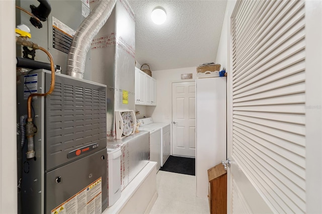 8537 SE 177th Bartram Loop, The Villages, FL 32162 - laundry room with separate washer and dryer, cabinet space, a textured ceiling, light flooring, and heating unit