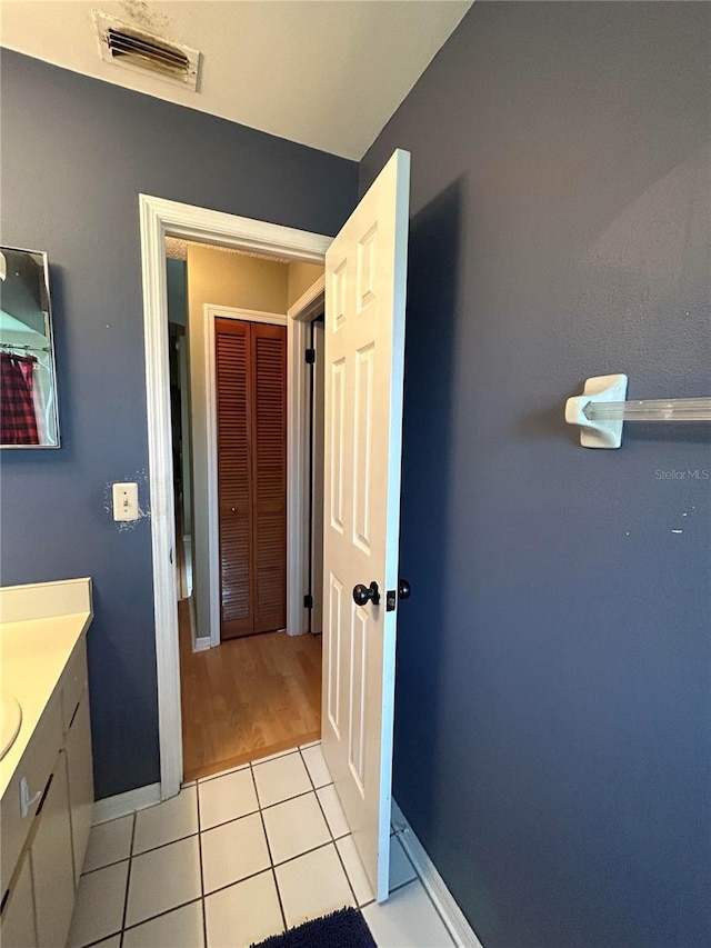 9375 Woodbreeze Blvd, Windermere, FL 34786 - bathroom featuring vanity, tile patterned flooring, and baseboards