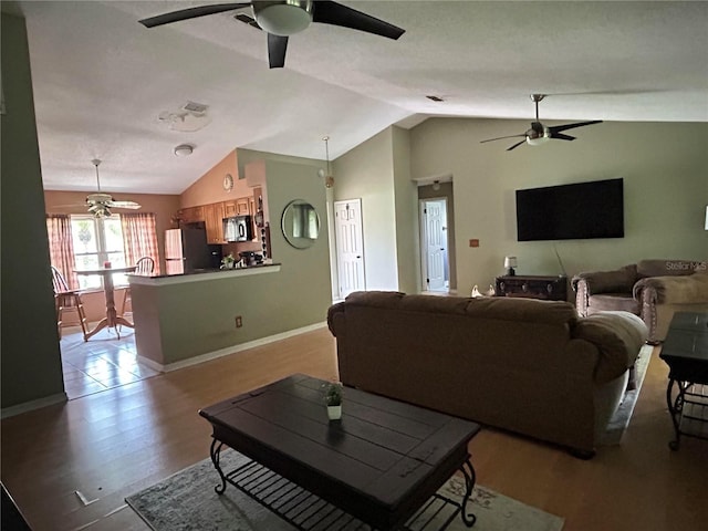 9375 Woodbreeze Blvd, Windermere, FL 34786 - living area with a ceiling fan, lofted ceiling, wood finished floors, and baseboards