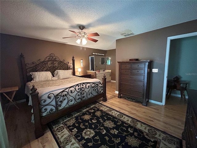 9375 Woodbreeze Blvd, Windermere, FL 34786 - bedroom featuring a textured ceiling, light wood-style flooring, baseboards, and ceiling fan