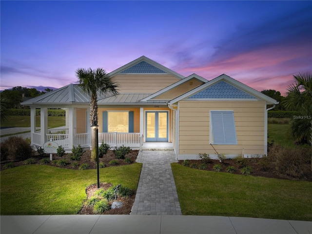 1042 Sugarloaf Key Loop, Lady Lake, FL 32159 - view of front of property featuring covered porch, a yard, and french doors