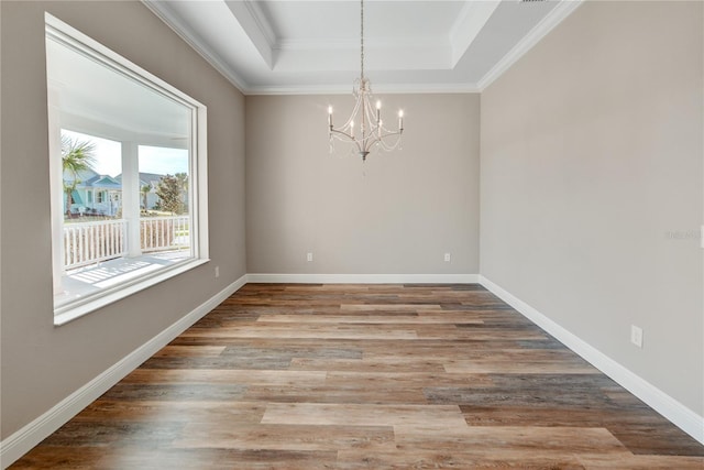 1042 Sugarloaf Key Loop, Lady Lake, FL 32159 - empty room featuring a chandelier, a raised ceiling, wood finished floors, and ornamental molding