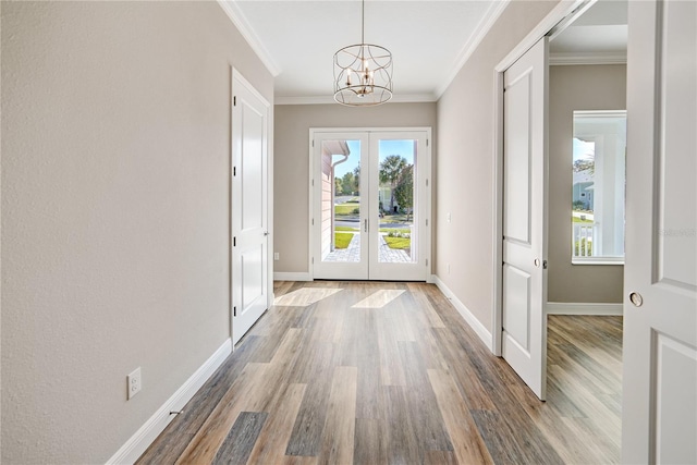 1042 Sugarloaf Key Loop, Lady Lake, FL 32159 - entrance foyer with french doors, a chandelier, wood finished floors, and ornamental molding