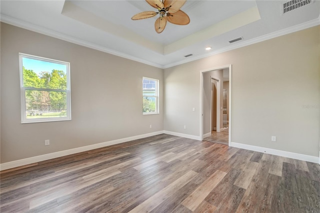 1042 Sugarloaf Key Loop, Lady Lake, FL 32159 - spare room with a tray ceiling, wood finished floors, ceiling fan, crown molding, and recessed lighting