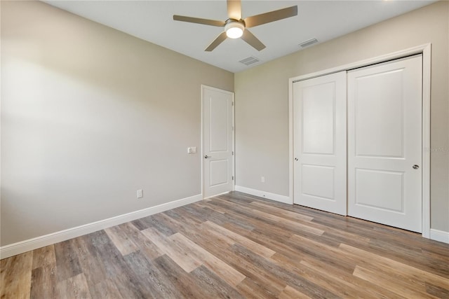 1042 Sugarloaf Key Loop, Lady Lake, FL 32159 - unfurnished bedroom with light wood-style floors, a closet, and ceiling fan