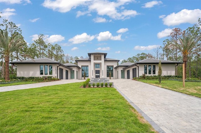 16320 Pendio Dr, Bella Collina, FL 34756 - prairie-style house featuring an attached garage, decorative driveway, and stucco siding