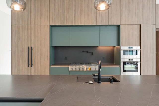 16320 Pendio Dr, Bella Collina, FL 34756 - kitchen with modern cabinets, appliances with stainless steel finishes, tasteful backsplash, light brown cabinetry, and a sink