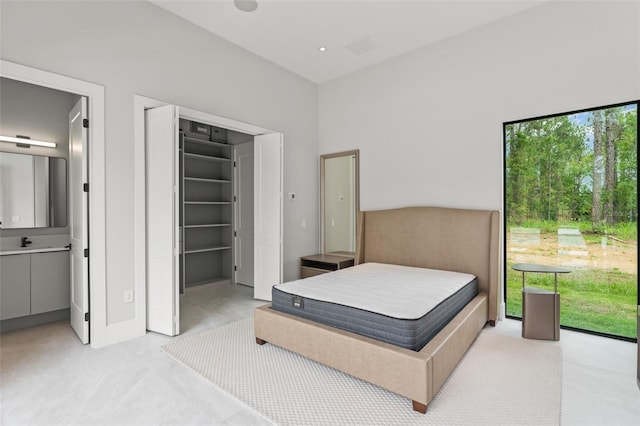 16320 Pendio Dr, Bella Collina, FL 34756 - bedroom featuring a walk in closet, light colored carpet, and baseboards