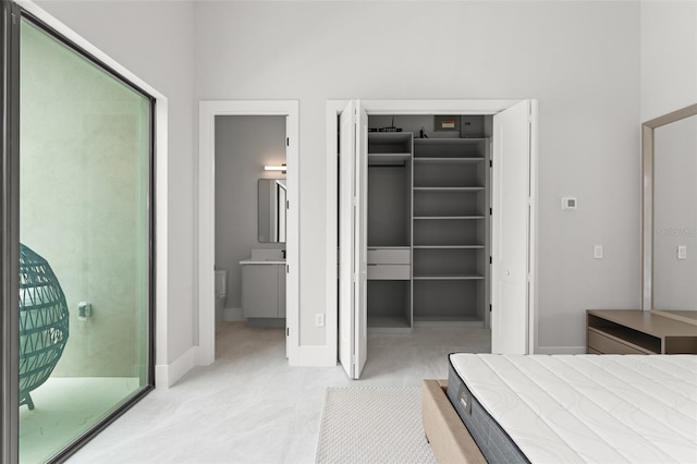 16320 Pendio Dr, Bella Collina, FL 34756 - bedroom with a walk in closet, baseboards, access to outside, a closet, and connected bathroom