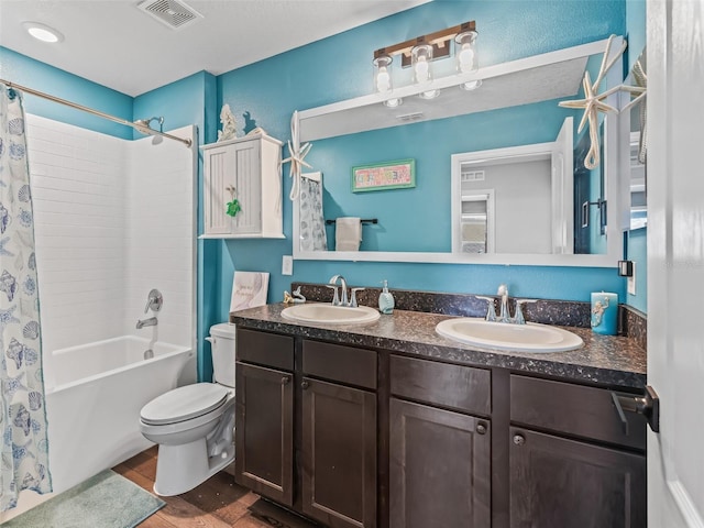 1824 Forest Glen Dr, Fruitland Park, FL 34731 - full bathroom with toilet, double vanity, shower / bath combo, and wood finished floors