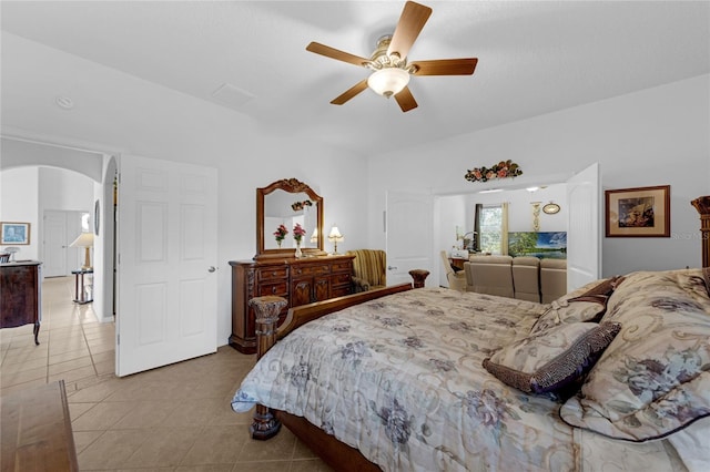 316 Dupont Cir, Howey In The Hills, FL 34737 - bedroom with arched walkways, tile patterned flooring, and a ceiling fan