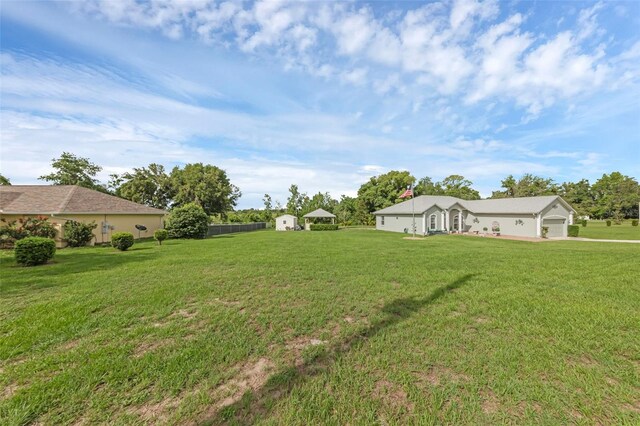 316 Dupont Cir, Howey In The Hills, FL 34737 - view of grassy yard with a garage