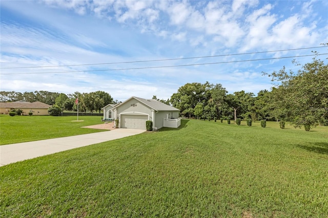 316 Dupont Cir, Howey In The Hills, FL 34737 - view of green lawn featuring concrete driveway and an attached garage