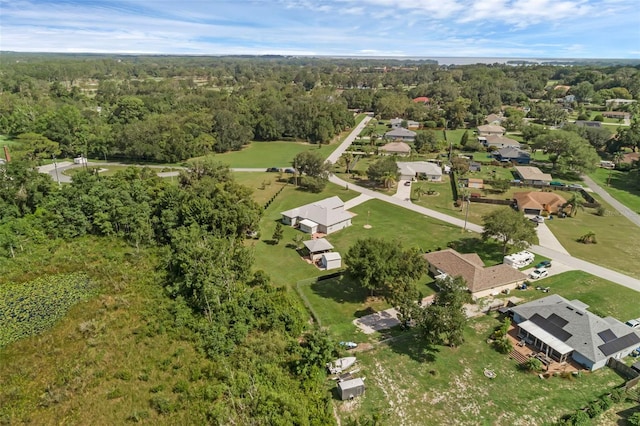 316 Dupont Cir, Howey In The Hills, FL 34737 - aerial view of property and surrounding area featuring a forest and nearby suburban area