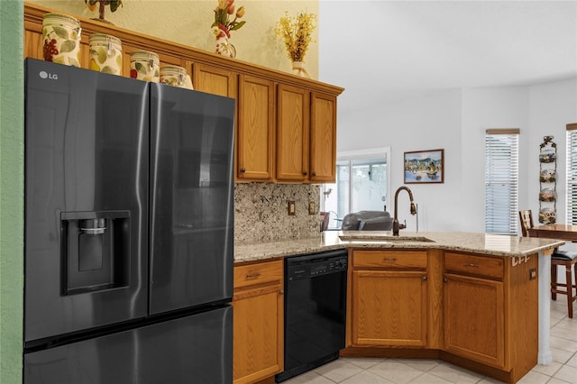 316 Dupont Cir, Howey In The Hills, FL 34737 - kitchen featuring refrigerator with ice dispenser, black dishwasher, a peninsula, a sink, and brown cabinetry