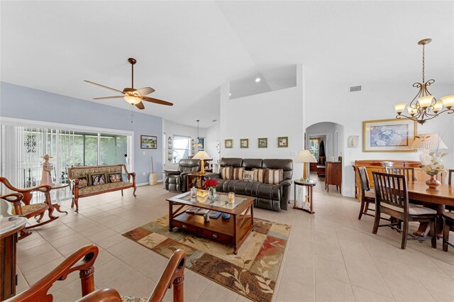 316 Dupont Cir, Howey In The Hills, FL 34737 - living area with arched walkways, ceiling fan, light tile patterned floors, a chandelier, and a towering ceiling