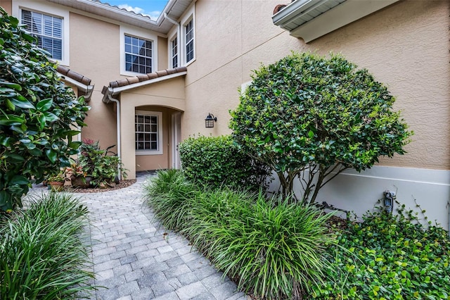 52 Camino Real Blvd, Howey In The Hills, FL 34737 - view of exterior entry featuring stucco siding and a tile roof