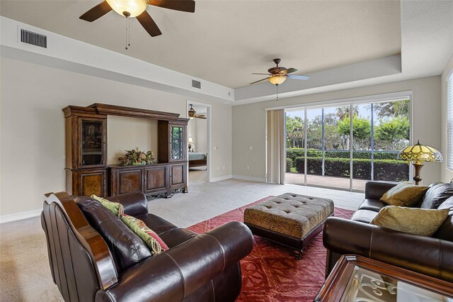 52 Camino Real Blvd, Howey In The Hills, FL 34737 - living area with a ceiling fan, light colored carpet, baseboards, and a raised ceiling