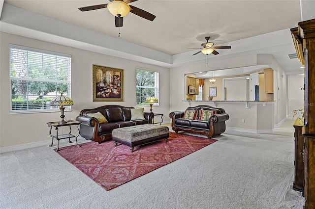 52 Camino Real Blvd, Howey In The Hills, FL 34737 - living area with ceiling fan, light carpet, and baseboards