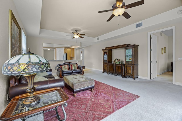 52 Camino Real Blvd, Howey In The Hills, FL 34737 - living area with a ceiling fan, light colored carpet, baseboards, and healthy amount of natural light