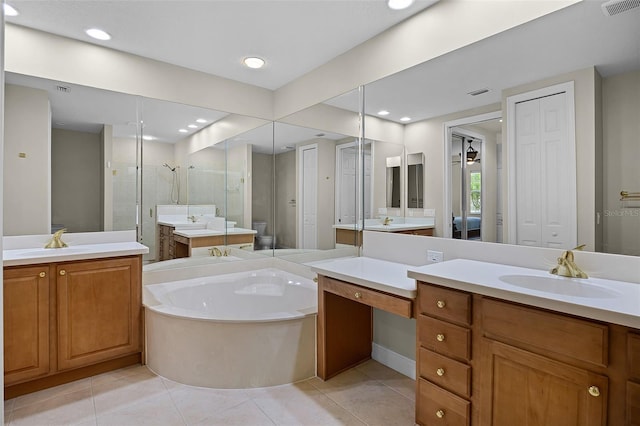 52 Camino Real Blvd, Howey In The Hills, FL 34737 - bathroom featuring a garden tub, a stall shower, tile patterned flooring, two vanities, and recessed lighting