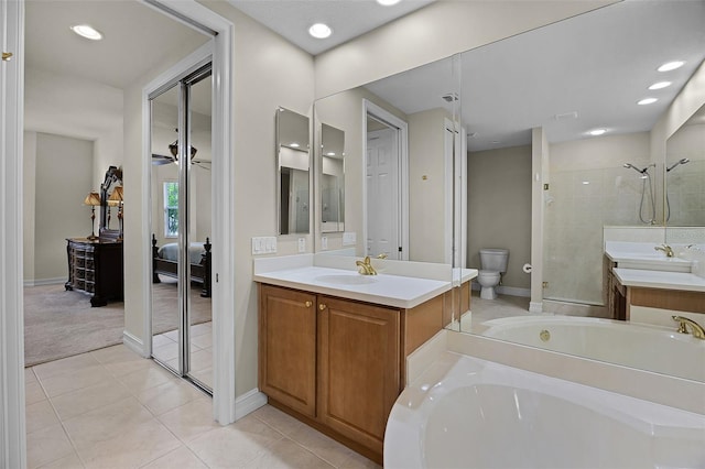 52 Camino Real Blvd, Howey In The Hills, FL 34737 - ensuite bathroom featuring toilet, a bath, tile patterned floors, vanity, and recessed lighting