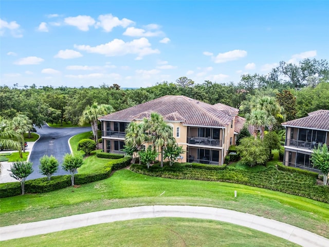52 Camino Real Blvd, Howey In The Hills, FL 34737 - aerial view of property and surrounding area with a tree filled landscape