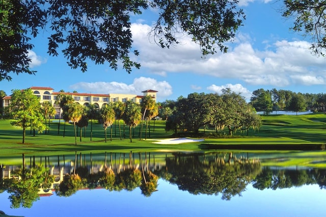 52 Camino Real Blvd, Howey In The Hills, FL 34737 - view of home's community with a lawn, golf course view, and a water view