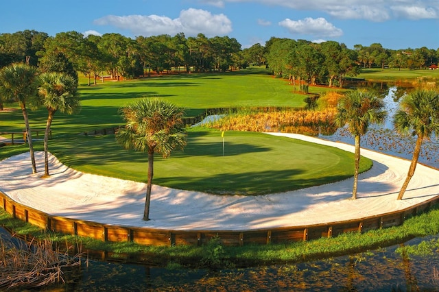 52 Camino Real Blvd, Howey In The Hills, FL 34737 - surrounding community featuring a water view, golf course view, view of scattered trees, and a putting green