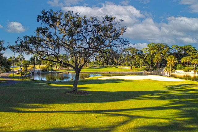 52 Camino Real Blvd, Howey In The Hills, FL 34737 - view of home's community featuring a water view, a yard, view of golf course, and view of wooded area