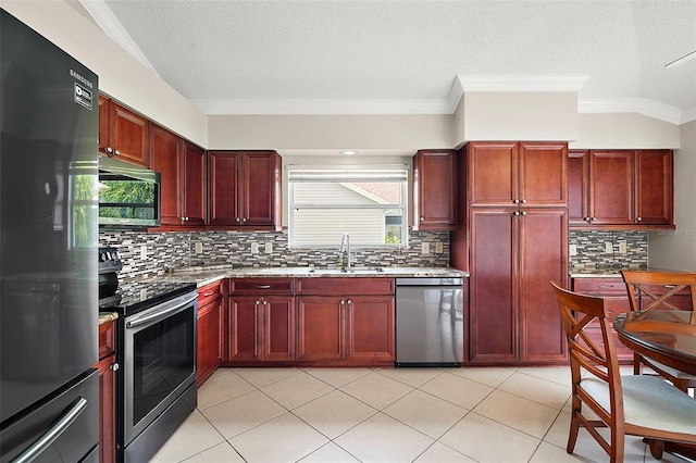 2104 Gerardo Ave, The Villages, FL 32159 - kitchen featuring stainless steel appliances, reddish brown cabinets, a sink, decorative backsplash, and ornamental molding