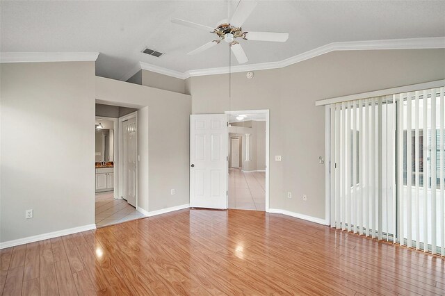 2104 Gerardo Ave, The Villages, FL 32159 - spare room featuring a ceiling fan, ornamental molding, vaulted ceiling, light wood-style flooring, and baseboards
