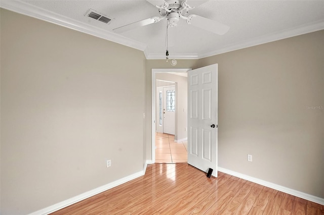 2104 Gerardo Ave, The Villages, FL 32159 - unfurnished room with ceiling fan, ornamental molding, baseboards, and light wood-type flooring