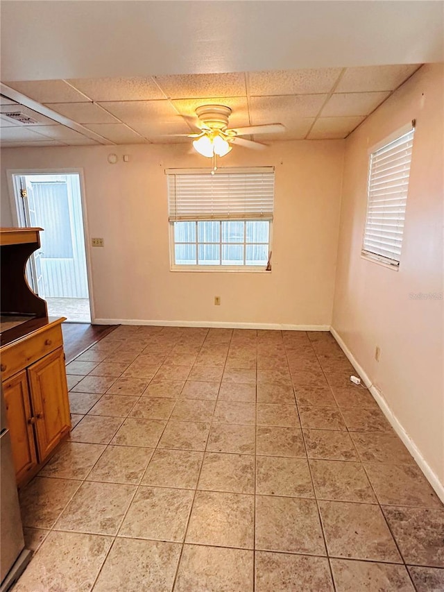 679 Ave Q SE, Winter Haven, FL 33880 - unfurnished dining area with a drop ceiling, a ceiling fan, and light tile patterned floors