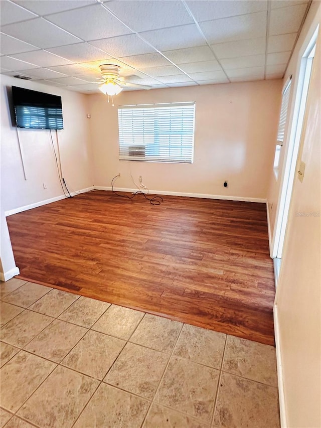 679 Ave Q SE, Winter Haven, FL 33880 - empty room with light tile patterned flooring, a paneled ceiling, and ceiling fan