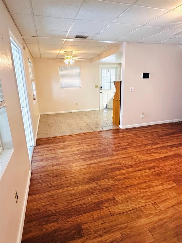 679 Ave Q SE, Winter Haven, FL 33880 - empty room with a drop ceiling, wood finished floors, and ceiling fan