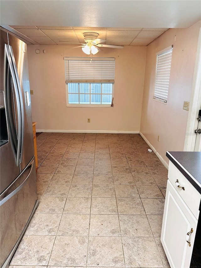 679 Ave Q SE, Winter Haven, FL 33880 - kitchen featuring stainless steel fridge with ice dispenser, a drop ceiling, ceiling fan, light tile patterned floors, and dark countertops